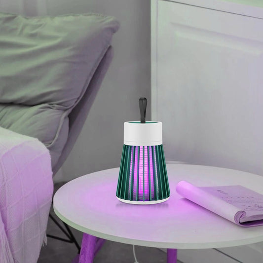Futuristic lamp on a small round table with a bed and purple blanket in the background