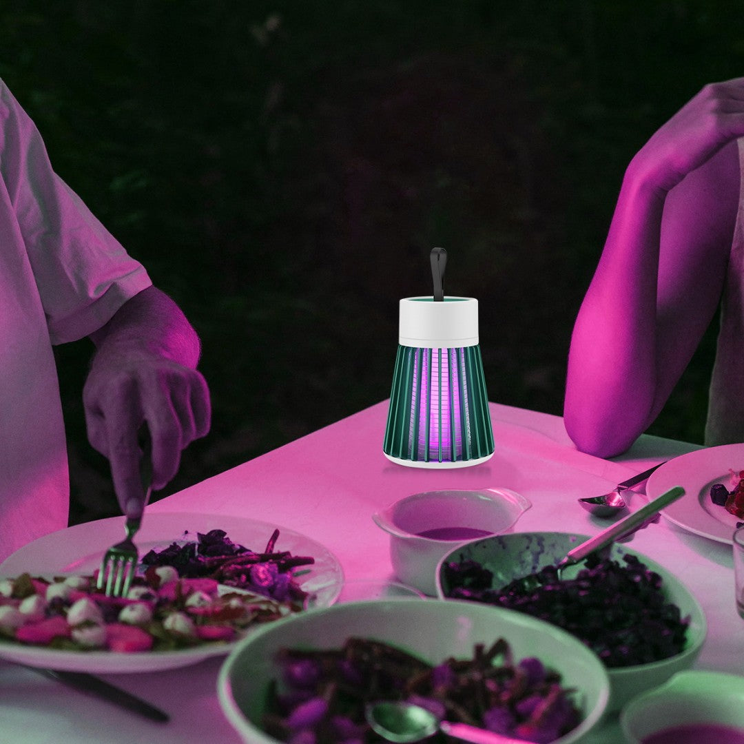 Person in purple gloves preparing food with a glowing lamp on a pink-lit table.