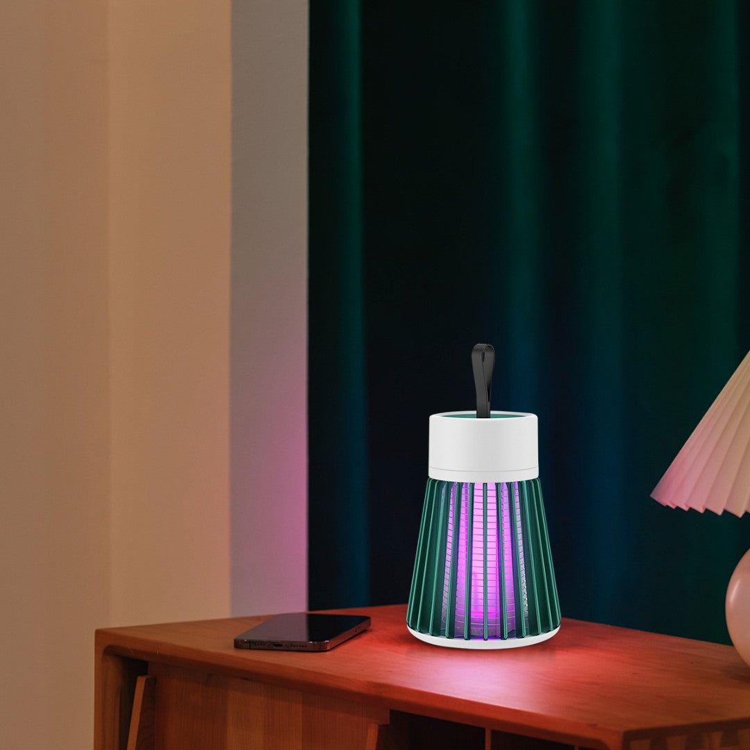 Futuristic lamp with colorful design on a wooden surface against a striped wall.